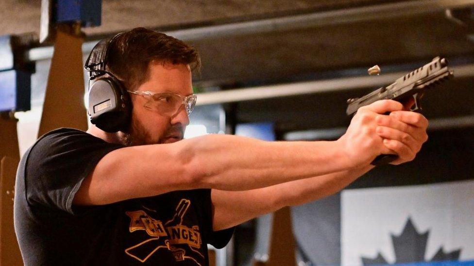 Andrew Trafananko, General Manager of the Range Langley, British Columbia, fires a handgun after Canada's government introduced legislation to implement a "national freeze" on the sale and purchase of handguns, 31 May 2022.