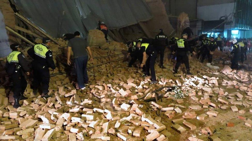 Police and passers-by look for victims in the rubble minutes after the collapse of the old Parravicini movie theatre building, in Tucuman, Argentina on May 23, 2018.