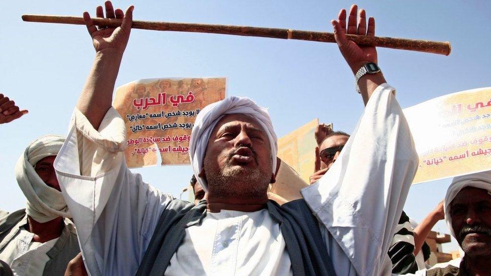 Supporters of the Sudanese army rally outside the office of the United Nations mission, west of Sudan's capital Khartoum, on February 5, 2022