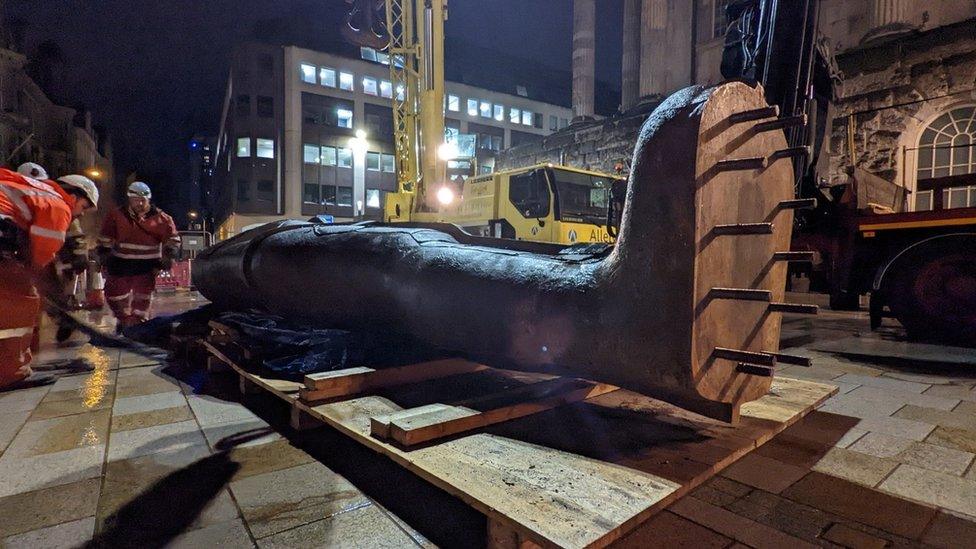 The statue before being lifted into position