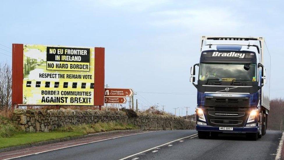 Traffic passing a Brexit Border poster on the Dublin road Co Armagh border