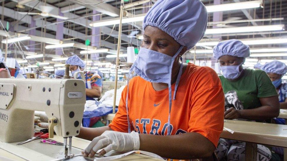 Woman sewing a face mask in a factory