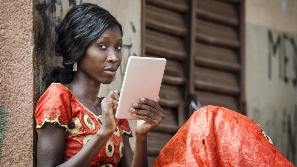 Young female student posing with tablet