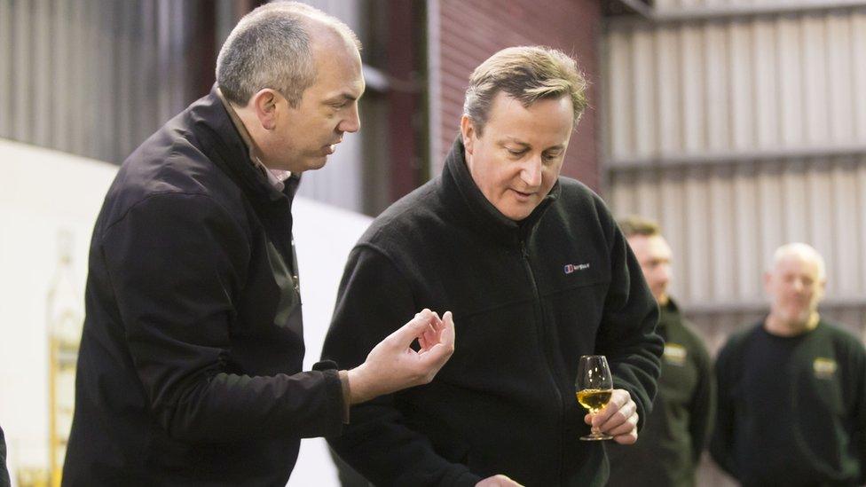 David Cameron speaks to the master distiller at Old Bushmills whiskey distillery