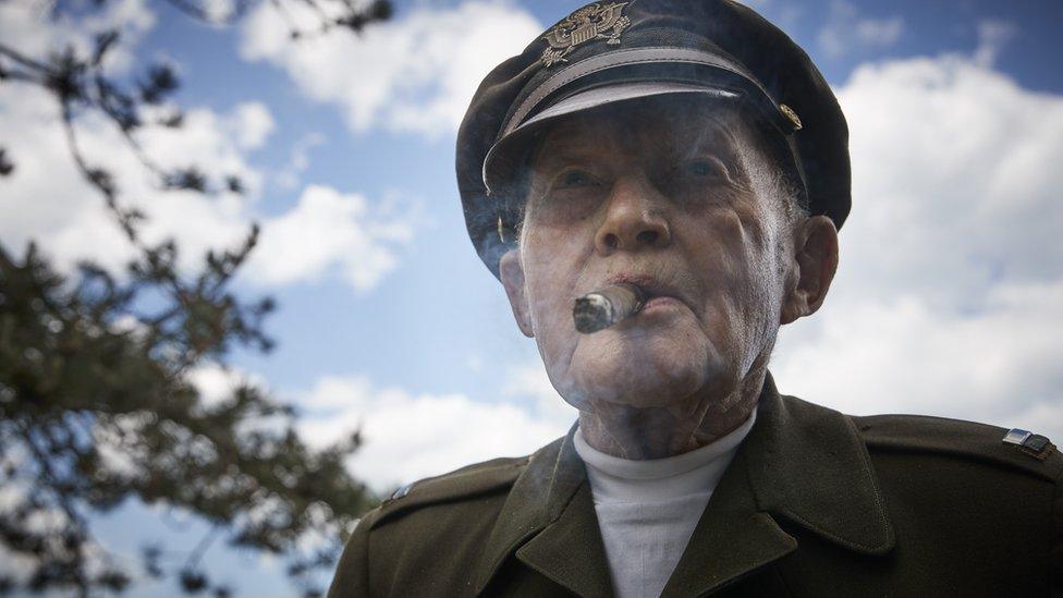 World War Two veteran Dennis Thompson enjoys a cigar in his original uniform