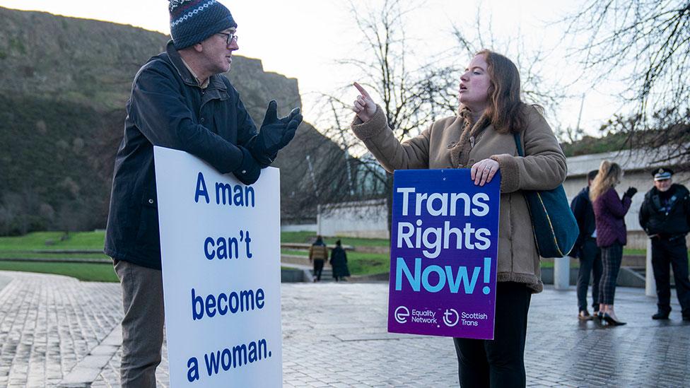 Supporter and opponent of the bill outside the Scottish Parliament