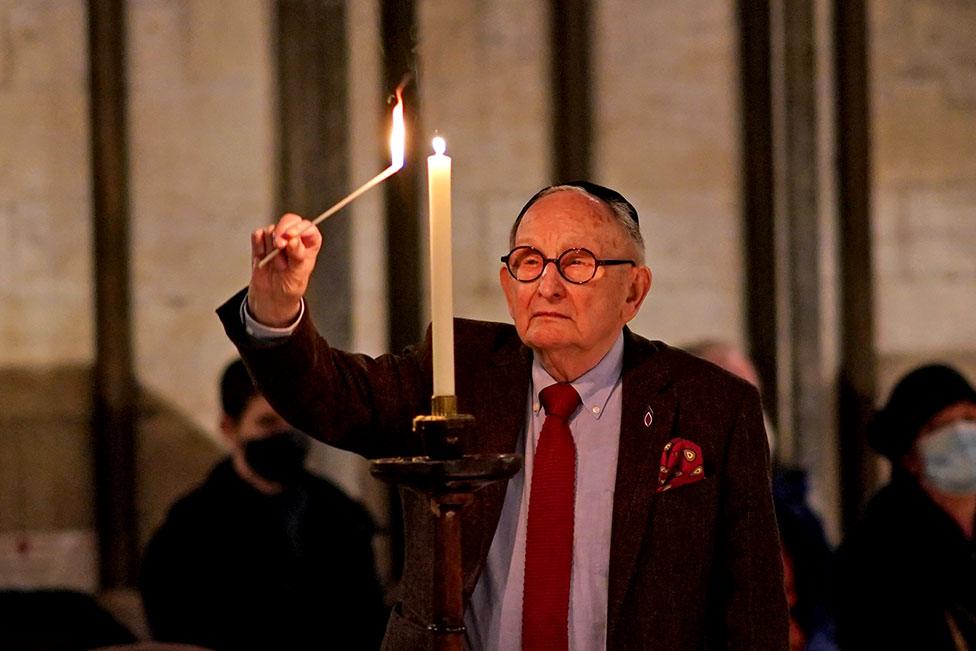 A Jewish man helps light six hundred candles in the shape of the Star of David, in the Chapter House at York Minster in York, part of York Minster's commemoration for International Holocaust Day