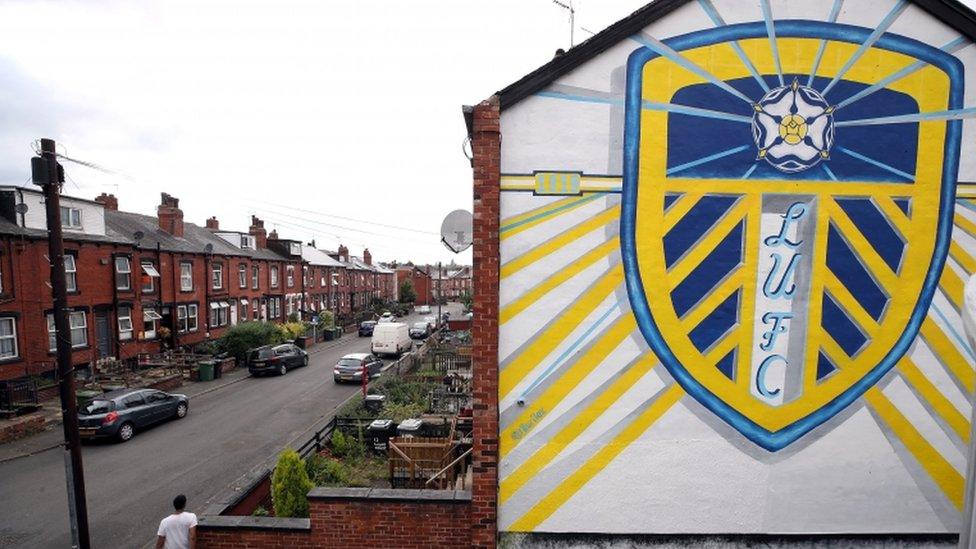 A Leeds crest on the side of a house