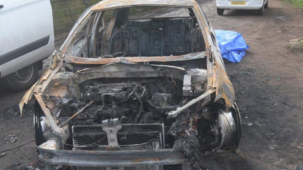 The stolen car used in the drive-by shooting was found burned out