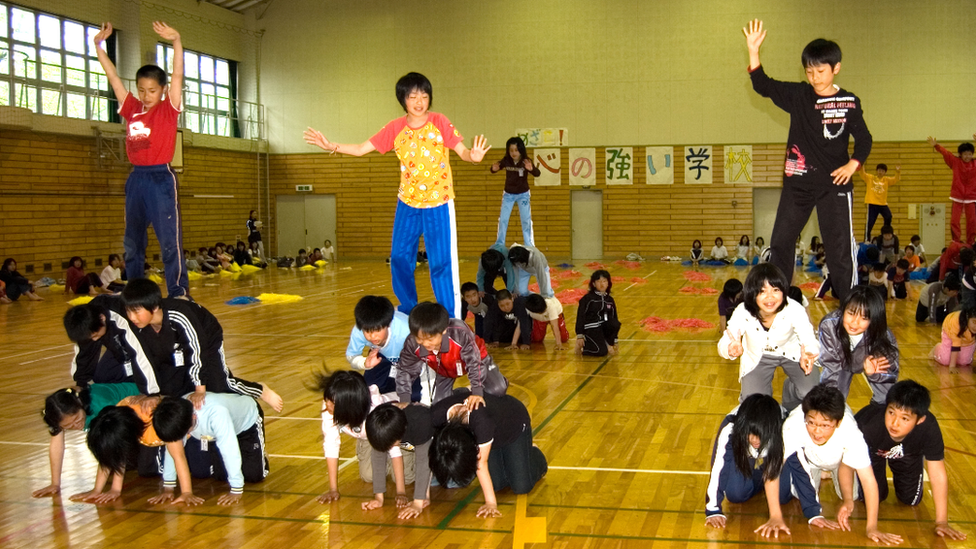 Japanese children building human pyramids