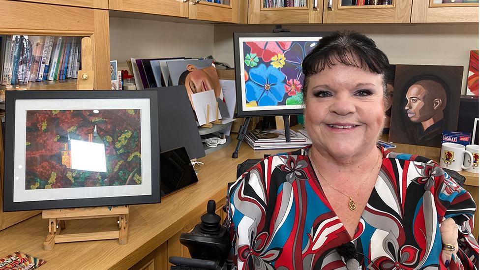 Rosaleen Moriarty-Simmonds in an office beside a painting