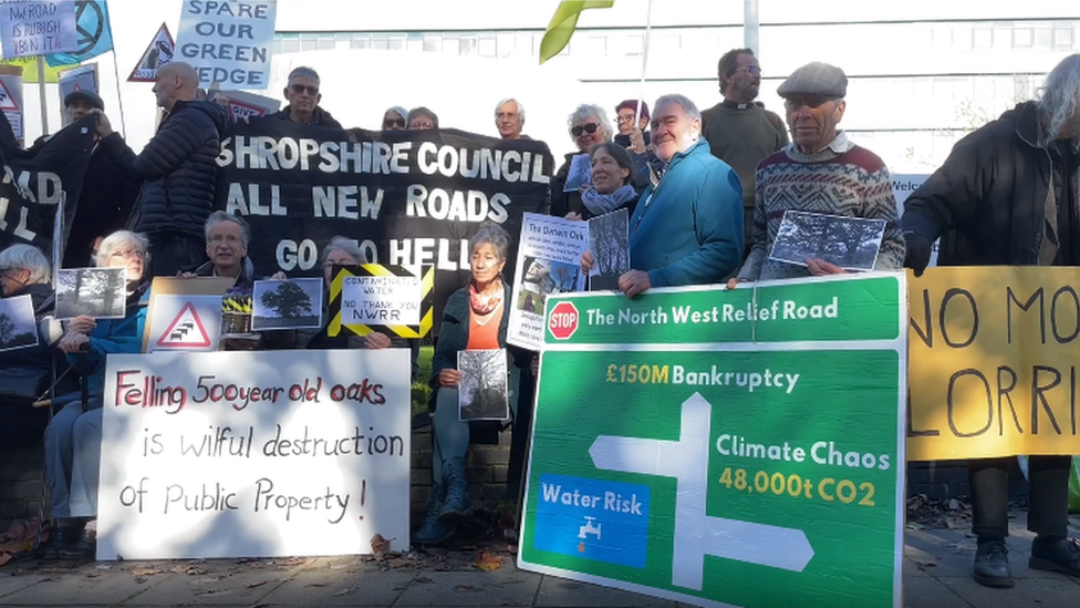 Protesters outside the meeting