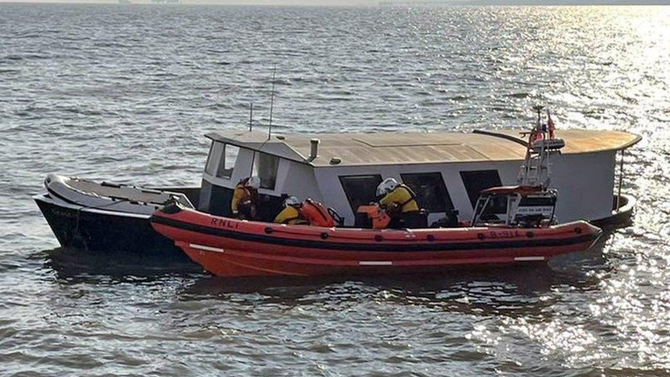 The sinking trawler and a life boat