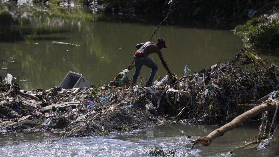 A man crosses a river, in Santo Domingo, Dominican Republic, 05 November 2022.