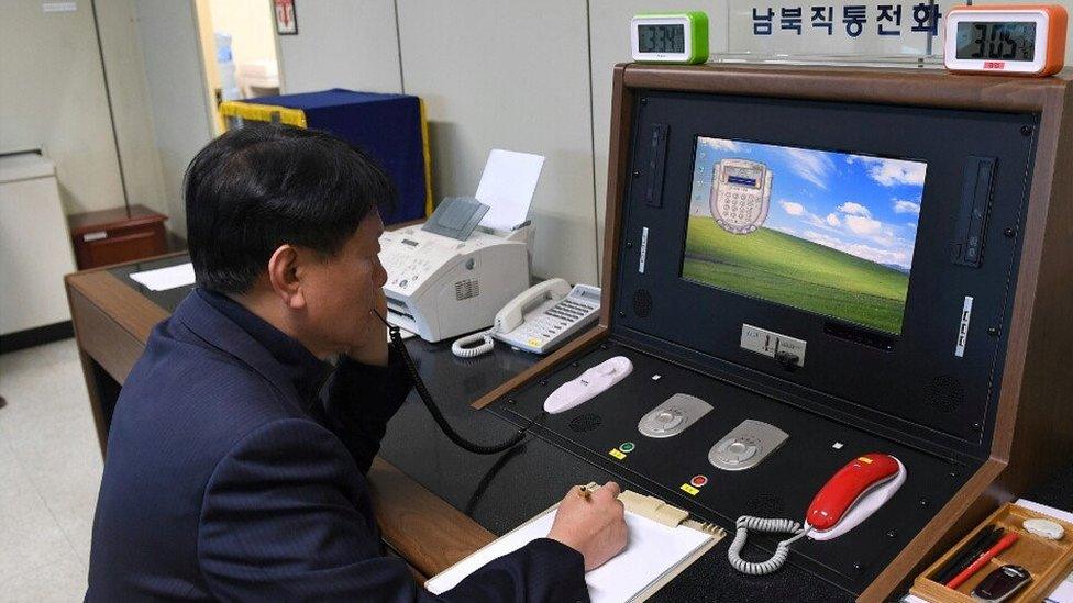 A South Korean official checks the hotline to North Korea at Panmunjom