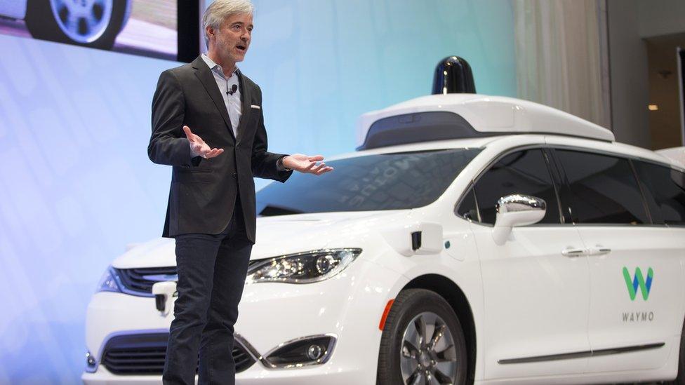 John Krafcik and a Waymo vehicle