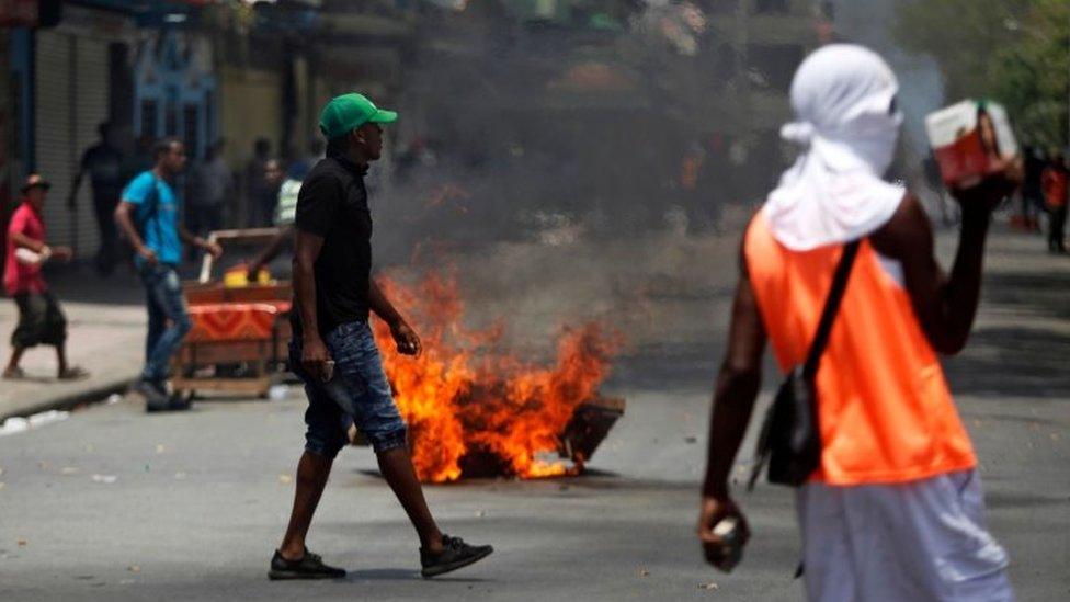 Protesters prepare to confront the police next to a fire in a street of Colon, Panama on March 13, 2018, during a general strike.