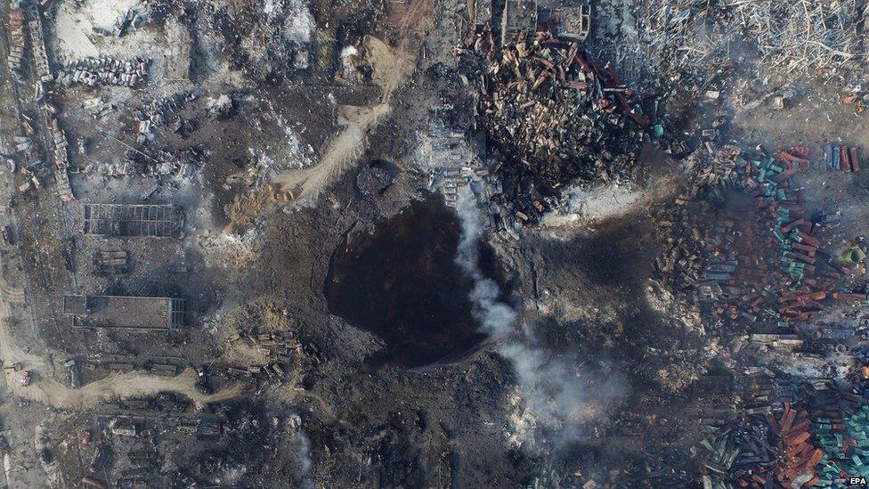 An aerial view of a large hole in the ground in the aftermath of a huge explosion that rocked the port city of Tianjin