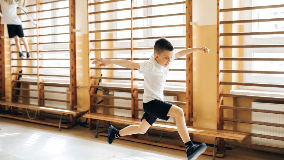 Boy running in PE hall