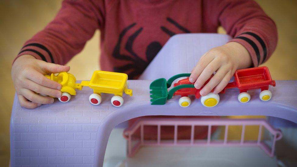 A young boy plays with toys at a playgroup