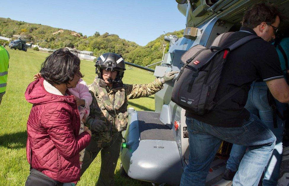 A handout photo taken and received on 15 November 2016, shows a New Zealand Defence Force helicopter evacuating some of 1,200 of tourists from Kaikoura stranded by a 7.8 earthquake that caused devastation on the east coast of the South Island.