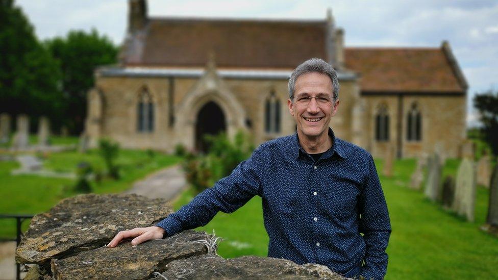 Tony Godwin in front of a church