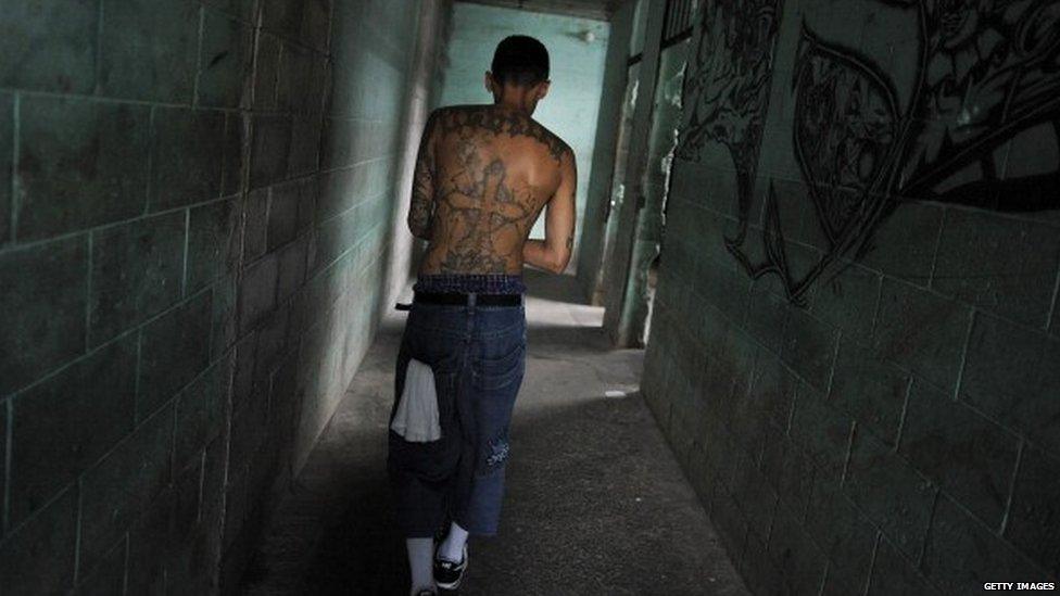 A member of the the 18th street gang walks down a hallway in the Quezaltepeque prison in 2012