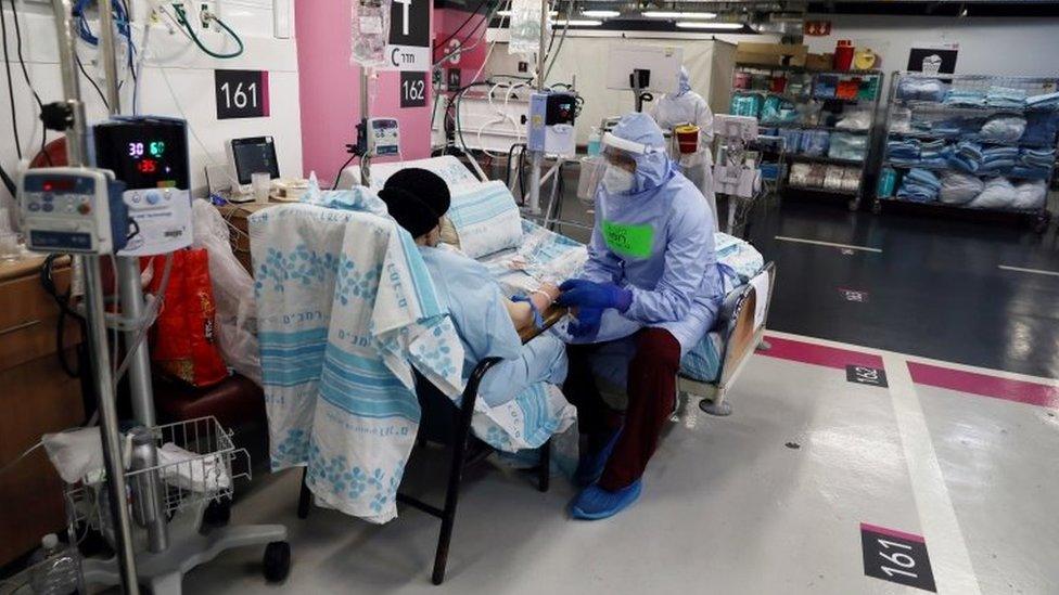 A medic treats a coronavirus patient in a car park at Rambam Health Care Campus, in Haifa, northern Israel September 30, 2020