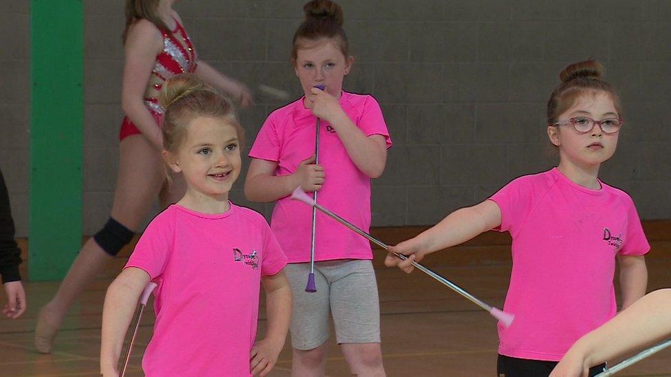 Children practising baton twirling