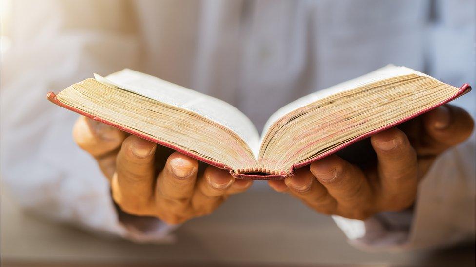 Hands and a book