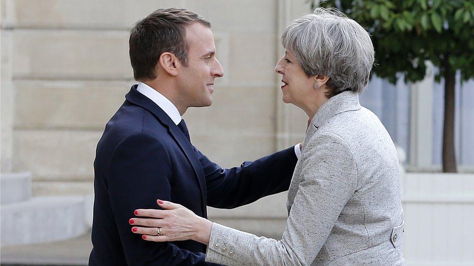 File pic: French President Emmanuel Macron welcomes British Prime Minister Theresa May prior to a working dinner at the Elysee Presidential Palace on June 13, 2017