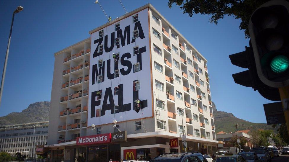 Zuma Must Fall banner hangs from building