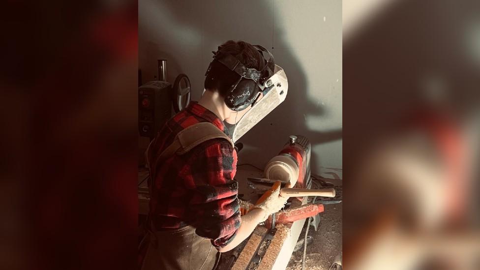 Gabriel making his wooden bowl