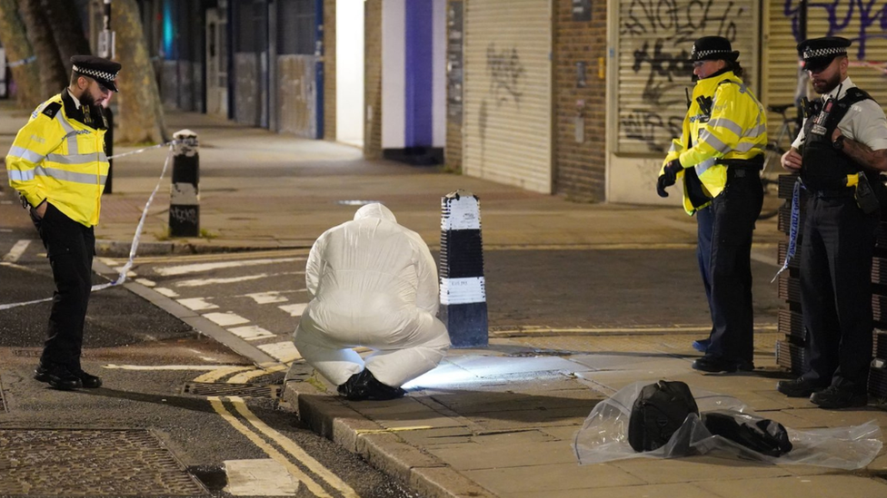 Forensic officers worked at the crime scene following the shooting