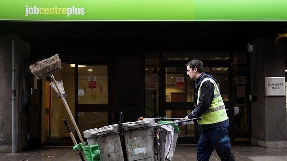 Street cleaner outside Job Centre Plus office in Bath