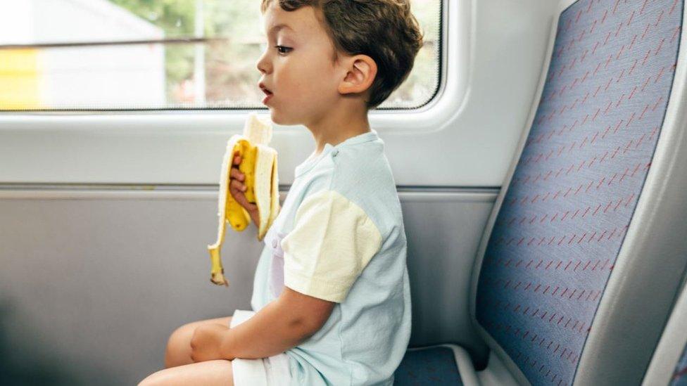 Boy eating banana