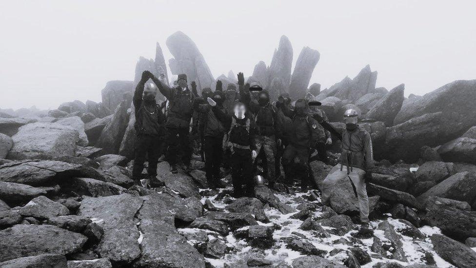 Members of White Stag Athletic Club perform a Nazi salute during a hike