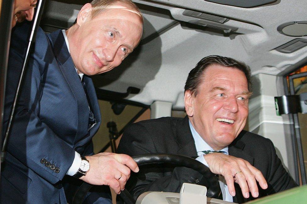 Russian President Vladimir Putin (L) and the German chancellor Gerhard Schroeder (R) poses in a Fendt tractor cabin at the opening of the Hanover Fair 2005, a trade fair for industrial technology at the Congress Centrum April 11, 2005 in Hanover, Germany.