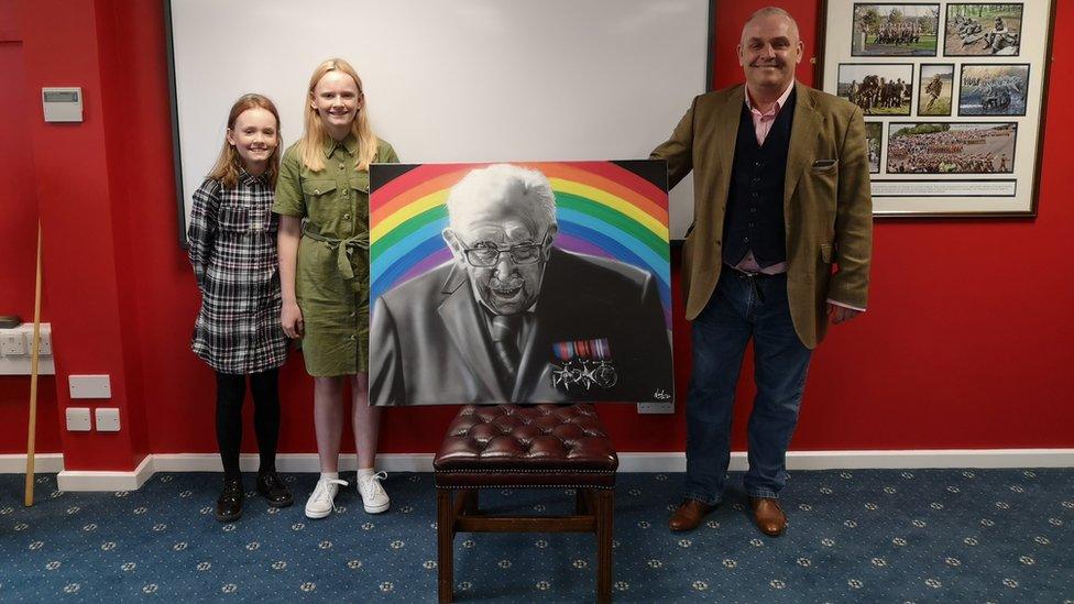 Artist Neil Arms pictured with his daughters