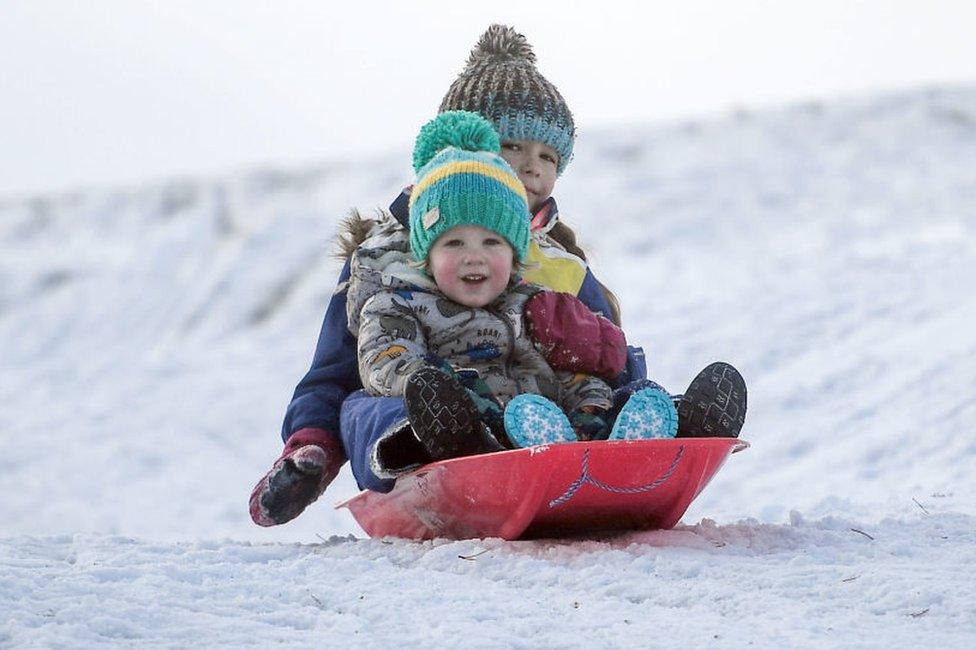 Children are seen sledging on a snow covered golf course on November 27, 2021 in Carrbidge, United Kingdom. The Met Office has issued the highest level of warning as wind speeds between 80 and 90mph hit north east Scotland and north east England bringing snow.