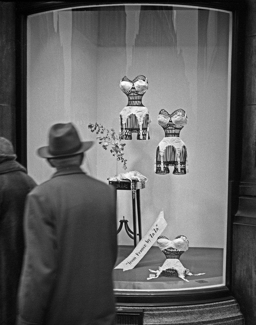 Man looking at ladies underwear in shop window, Bond Street, London, 1960