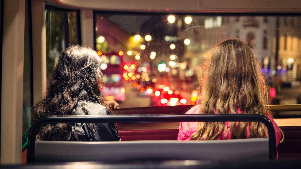 Two people sitting on London bus