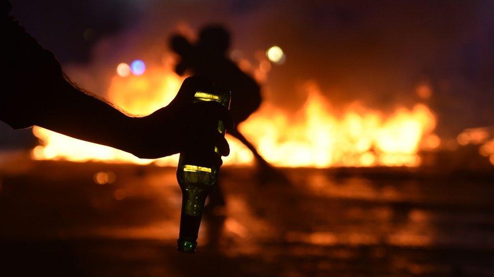 A protester holds a bottle to throw on July 7, 2017, in Hamburg