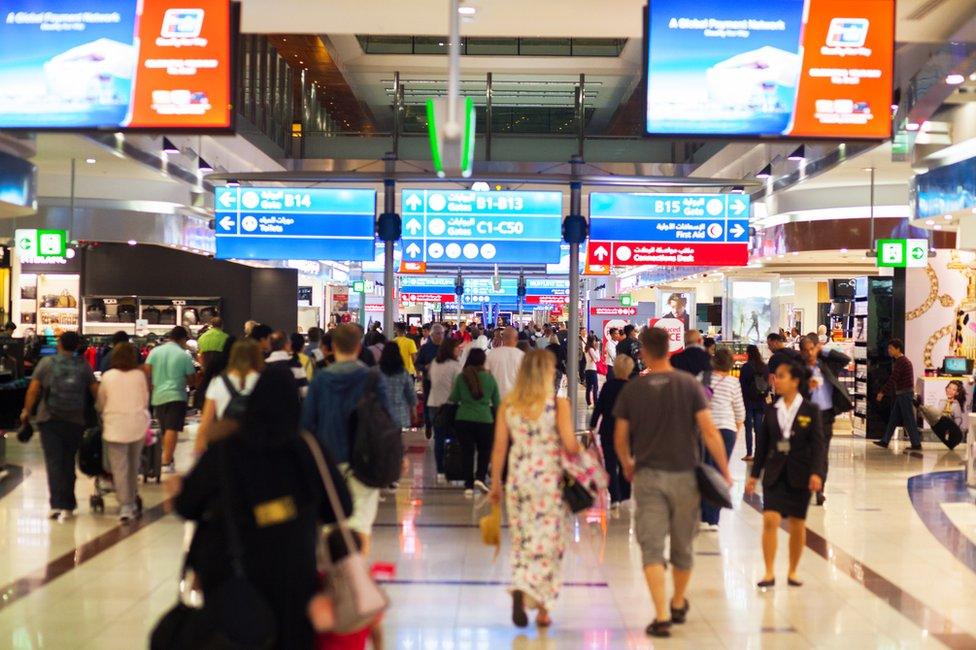 View into transit and duty free corridor in airport Dubai at night