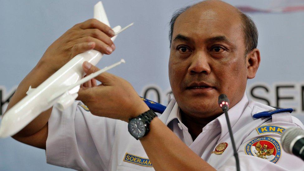 Chief of Indonesian transportation safety committee Soerjanto Tjahjono holds an aircraft model as he speaks to journalists during a press conference in Jakarta, Indonesia, 01 December 2015