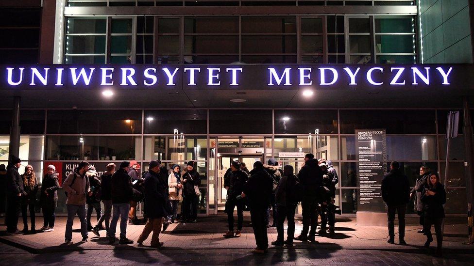 People gather at the entrance of the University Clinical Centre, in which the wounded Mayor of Gdansk Pawel Adamowicz is being treated