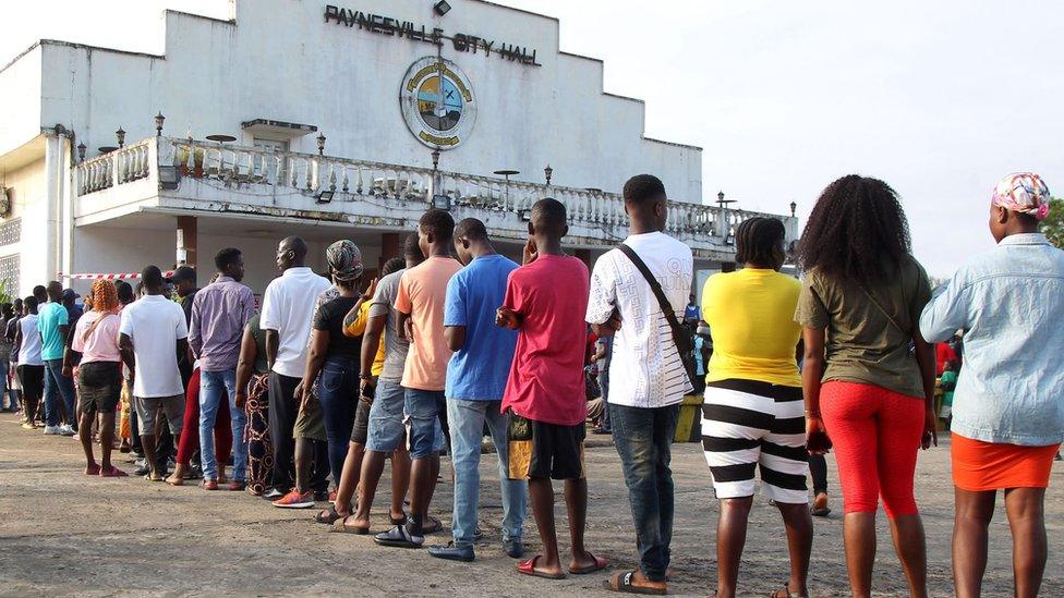 People queuing outside a polling station