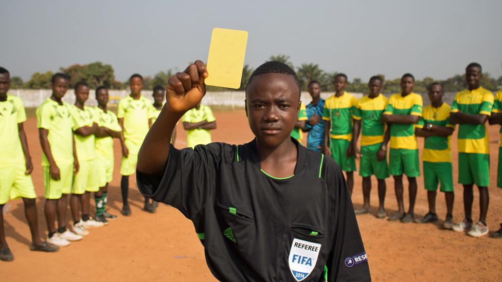 Isaac holds up his yellow card