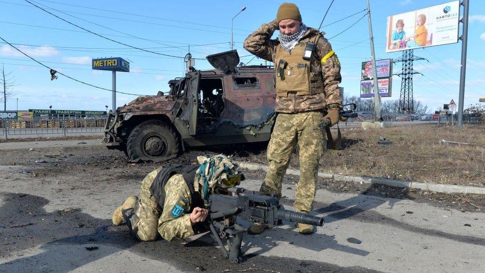 Ukrainian Territorial Defence fighters test the automatic grenade launcher taken from a destroyed Russian infantry mobility vehicle