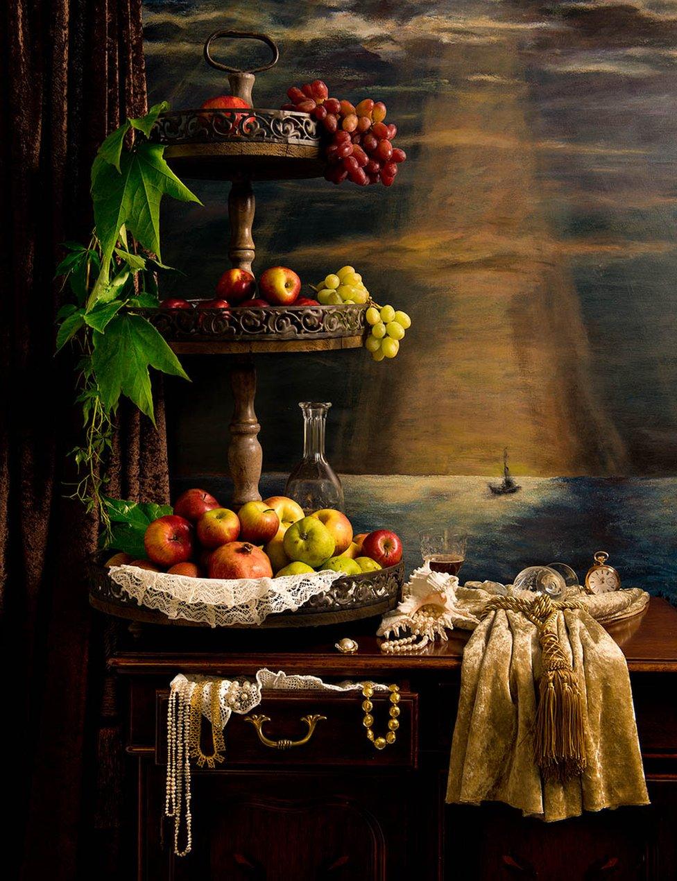 A wooden stand covered in fruit in front of a painting of a ship at sea